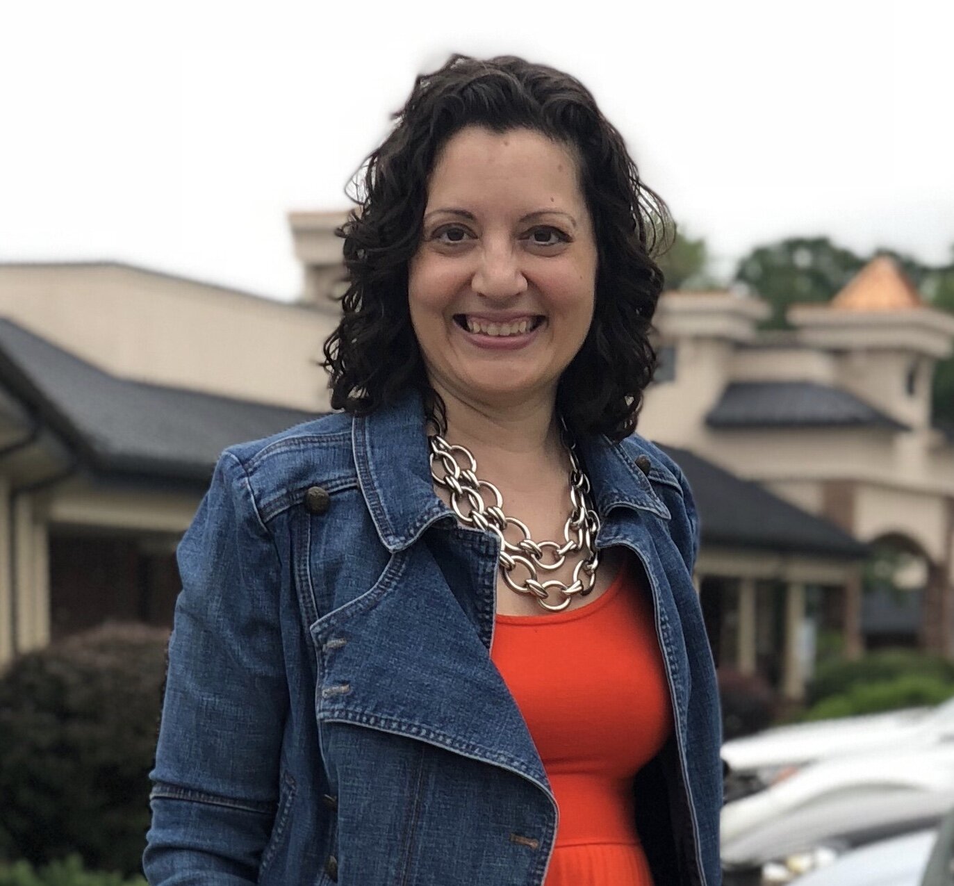 Lisa Batitto, founder of Enlightened Path Healing, beside a glowing salt rock